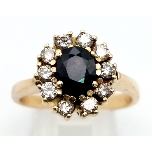 76 - A 14 k yellow gold ring with an oval cut sapphire surrounded by a halo of diamonds (0.5 carats). Rin... 