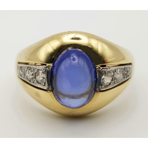 144 - An 18K Yellow Gold Blue Opal and Diamond Gents Ring. Central blue opal cabochon with two wings of th... 