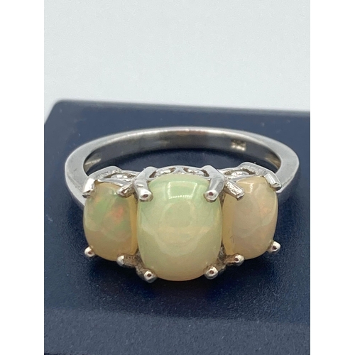 364 - SILVER and OPAL RING having three oval faux Opals set to top in attractive cradle mount. Size O.