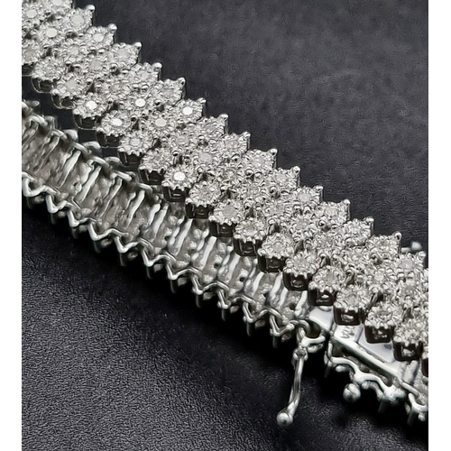 69 - A wonderful 9K white gold bracelet with three rows of diamonds (1.5 carats). Length: 19 cm, weight: ... 