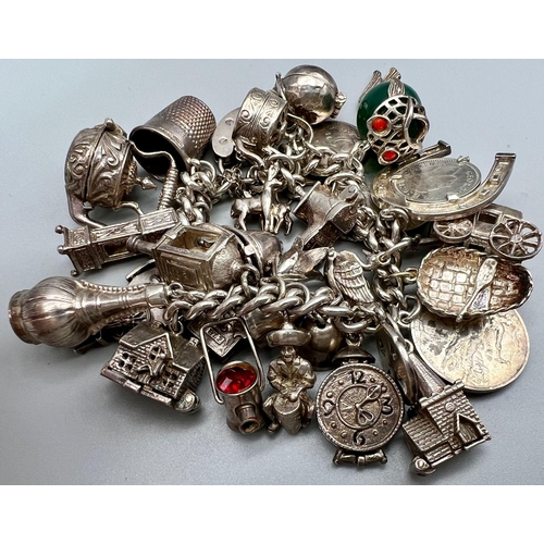 408 - A Vintage Silver Charm Bracelet. Over 25 charms! 109g total weight.