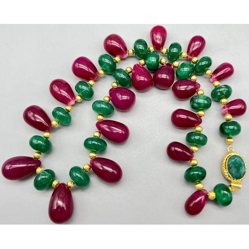 112 - A spectacular necklace with large, round emerald cabochons, large pear shaped ruby cabochons, and a ... 