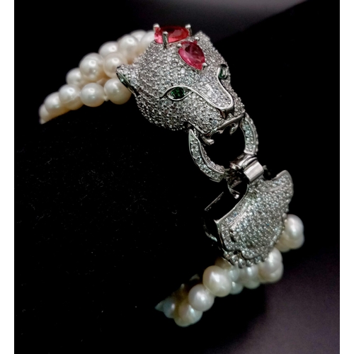 147 - A magnificent, seven row, white pearl, bracelet with an impressive Panther shaped clasp studded with... 