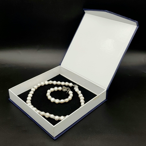 161 - A very elegant, natural, cultured, white pearl and cubic zirconia necklace and bracelet set with pan... 