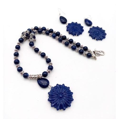 287 - A Tibetan silver and lapis lazuli necklace and earrings set with large, flower shaped, pendant parts... 