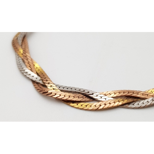 503 - An Italian 9K Tri-Coloured Gold Interwoven Bracelet. 16cm. 4.51g.