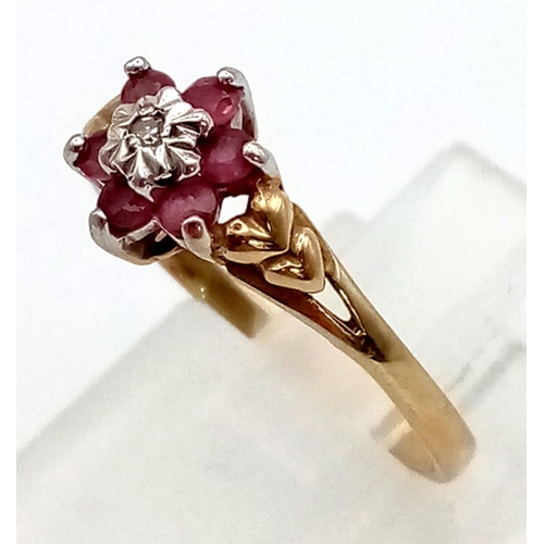 588 - 9k yellow gold vintage diamond and ruby cluster ring shaped in flower form, size  M and weight 1.4g