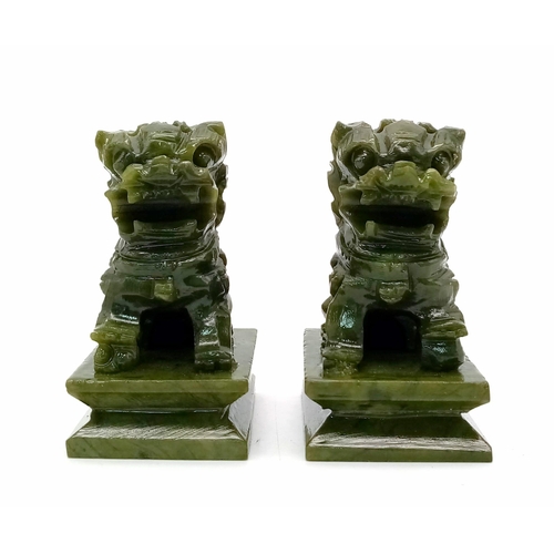 296 - A Pair of Miniature Jade Foo Dog Figures. 6.5cm tall.