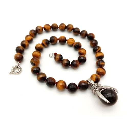 440 - A Tigers Eye Bead Necklace with a Tigers Eye Claw Pendant. Beads - 10mm. Pendant - 3cm. Necklace - 4... 