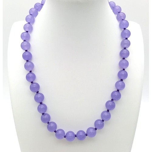 938 - A Purple Jade Bead Necklace. 10mm beads. 42cm.