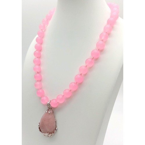 1070 - A Rose Quart Beaded Necklace with Teardrop Pendant. 10mm beads. 4cm pendant and 44cm necklace.