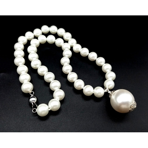 1074 - A South Sea Pearl Shell Necklace with Pendant. 20mm pendant. Necklace - 42cm