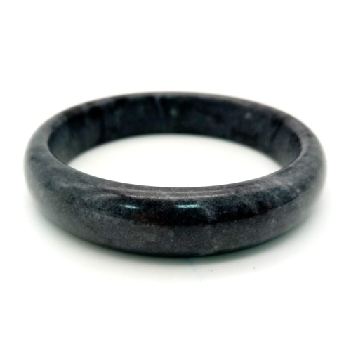 492 - A Shades of Grey Coloured Jade Bangle. 6cm inner diameter.