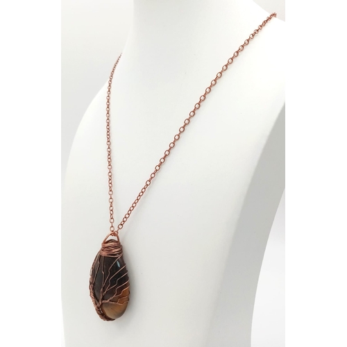 498 - A Tree of Life Tigers Eye Teardrop Pendant on a Red Metal Chain. 45mm.