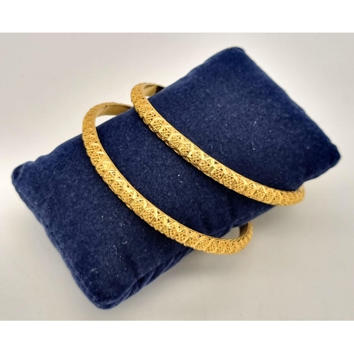 228 - A 22k Yellow Gold Lot Including: Two Asian wedding bangles (6cm inner diameter) and an Asian wedding... 