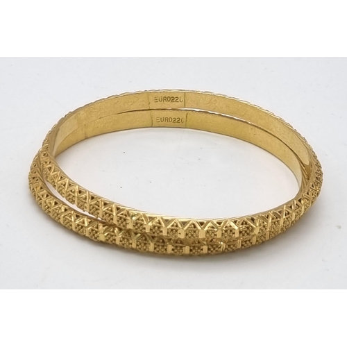 228 - A 22k Yellow Gold Lot Including: Two Asian wedding bangles (6cm inner diameter) and an Asian wedding... 