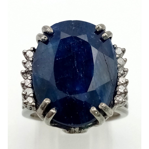 414 - A 20.30ct Oval cut Natural Blue Sapphire Ring set in 925 silver, decorated with 0.20ct Diamond Accen... 