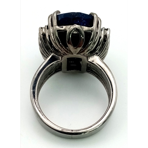 414 - A 20.30ct Oval cut Natural Blue Sapphire Ring set in 925 silver, decorated with 0.20ct Diamond Accen... 