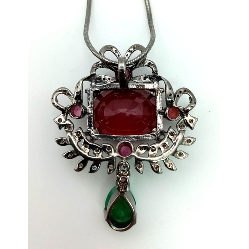 428 - An 18ct Natural Ruby and Emerald Drop Pendant set in 925 silver decorated with a 0.36ct Diamonds sur... 