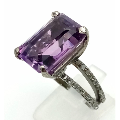 519 - A 14.35ct Natural Amethyst Ring set in 925 silver, decorated with 0.50cts Diamonds on the wings.
Siz... 