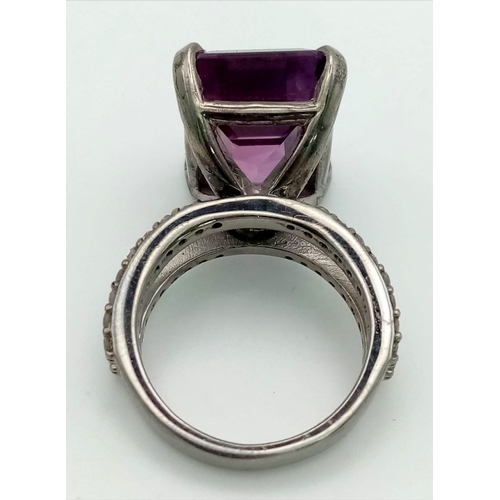 519 - A 14.35ct Natural Amethyst Ring set in 925 silver, decorated with 0.50cts Diamonds on the wings.
Siz... 