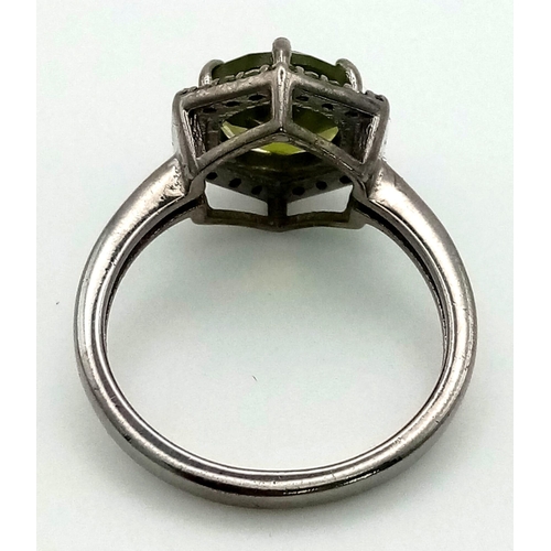 752 - A 2.90ct Natural Peridot Ring set in 925 silver, decorated with a 0.26ct Diamond surround. Size N. T... 