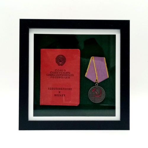 770 - A NICELY FRAMED RUSSIAN LABOUR CORPS BOOK AND MEDAL.    20 X 20cms