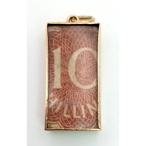 319 - A 9k gold 10 shilling note charm, circa 1960’s. 22mm by 11.5mm excluding loop. Weight 3.31g total.