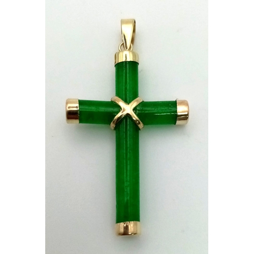 424 - A 14K Yellow Gold and Jade Cross Pendant. 39mm. 2.3g total weight.