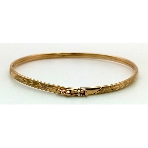 801 - A 14K Yellow Gold Bright Cut Satin-Finish Bangle. 3.4g