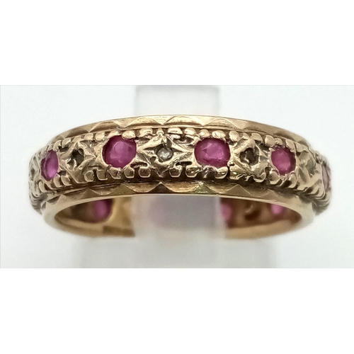 810 - A 9k gold ruby and diamond full eternity ring. Size N. Weight 3.7g.