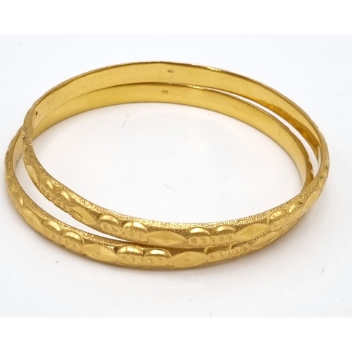 110 - A Mixed Gold Lot to Include: A 22K yellow gold selection of 10 bangles - 103.7g total weight - A/F. ... 