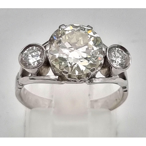 103 - An 18k White Gold 3.5ct Diamond Ring. A 3ct brilliant round cut centre diamond with a 0.25ct brillia... 