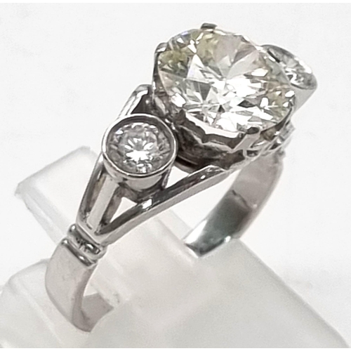 103 - An 18k White Gold 3.5ct Diamond Ring. A 3ct brilliant round cut centre diamond with a 0.25ct brillia... 