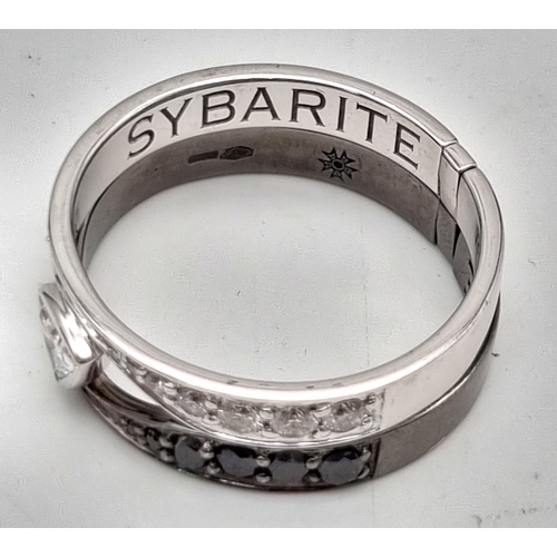 543 - A Sybarite 18k White and Black Gold Diamond Ring. Two bands with a heart-connector decorated with bl... 