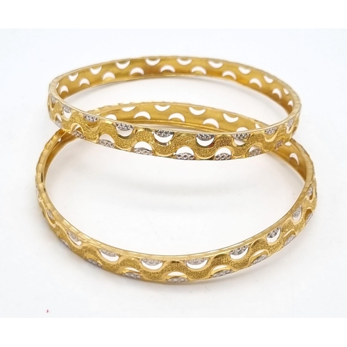 754 - Two 22k Yellow and White Gold Bangle Set. 6cm inner diameter. 16.1g total weight. Ref: 1-8273