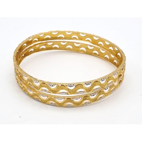 754 - Two 22k Yellow and White Gold Bangle Set. 6cm inner diameter. 16.1g total weight. Ref: 1-8273