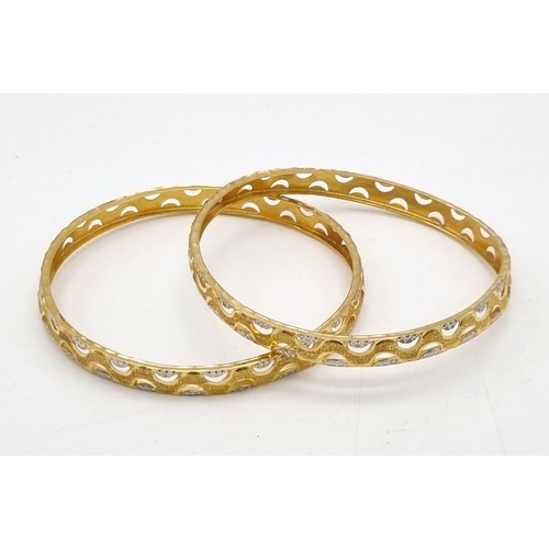 754 - Two 22k Yellow and White Gold Bangle Set. 6cm inner diameter. 16.1g total weight. Ref: 1-8273