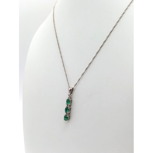 948 - A natural emerald and diamond trilogy 925 silver pendant and 18” Singapore twist chain. Emeralds mea... 