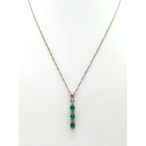 948 - A natural emerald and diamond trilogy 925 silver pendant and 18” Singapore twist chain. Emeralds mea... 