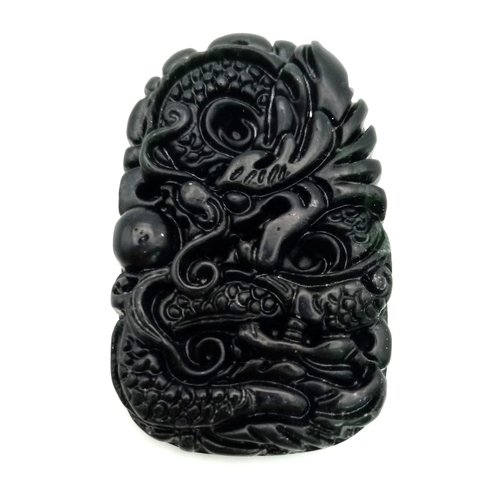 480 - A Black Dragon Carved Design Jade Pendant. 5cm.