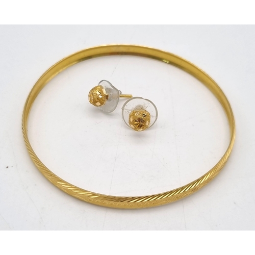 837 - A 21K Yellow Gold Slave Bangle - 6cm inner diameter - 8.53g and a Pair of 22K Gold Stud Earrings - 1... 