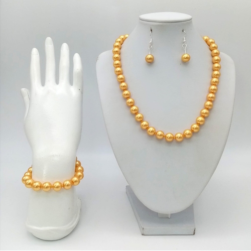 887 - A South Sea Pearl Shell Golden Necklace, Bracelet and Earring Set. 42cm. 16cm. 3cm drop.