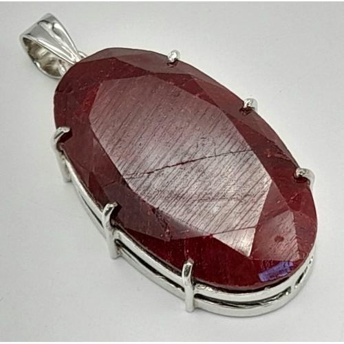 942 - A Massive 230ct Oval cut Ruby Pendant. Set In 925 Sterling Silver. 5.5 x 3cm. 71g total weight.