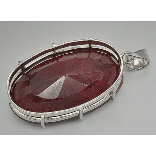 942 - A Massive 230ct Oval cut Ruby Pendant. Set In 925 Sterling Silver. 5.5 x 3cm. 71g total weight.