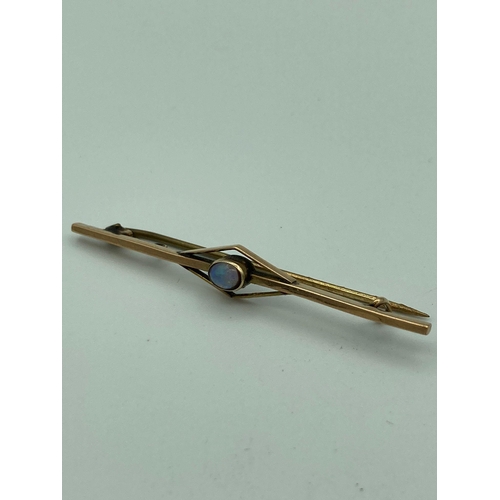 104 - Vintage 9 carat GOLD and OPAL BAR BROOCH, having Opal cabochon set to centre.
 1.8 grams. 5.75 cm ap... 