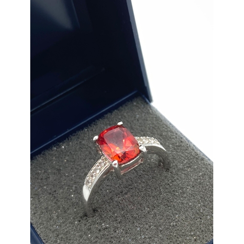 497 - SILVER RING set with large RED SPINEL SOLITAIRE (1.5 carat Emerald cut) ,and having WHITE TOPAZ deta... 