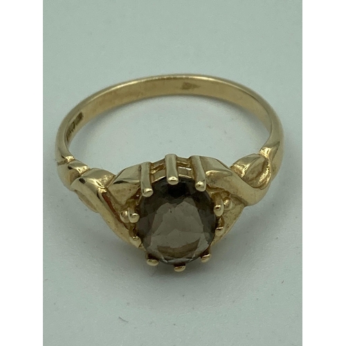 56 - Ladies 9 carat GOLD and SMOKY QUARTZ RING, having an oval 0.75 carat smoky quartz gemstone mounted t... 