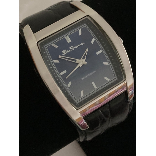 985 - Gentlemans quartz BEN SHERMAN wristwatch having large square face with silver digits and hands. Wide... 