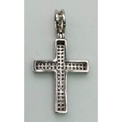 484 - 9k white gold diamond set cross pendant. 0.25ct, 1.8g.